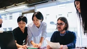 Group of people collaborating at an office table.