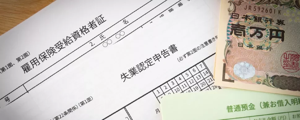Japanese unemployment document with yen currency notes.