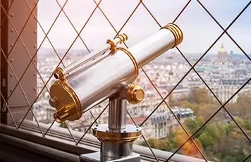 Viewing telescope overlooking a cityscape from a high vantage point.
